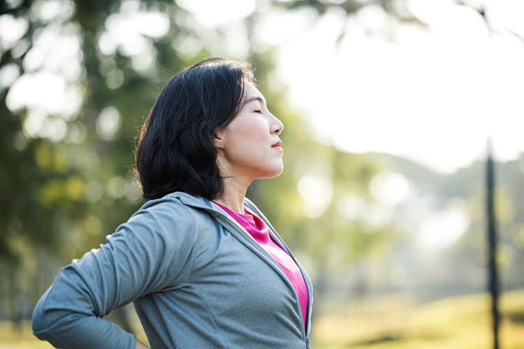 Woman meditating outside