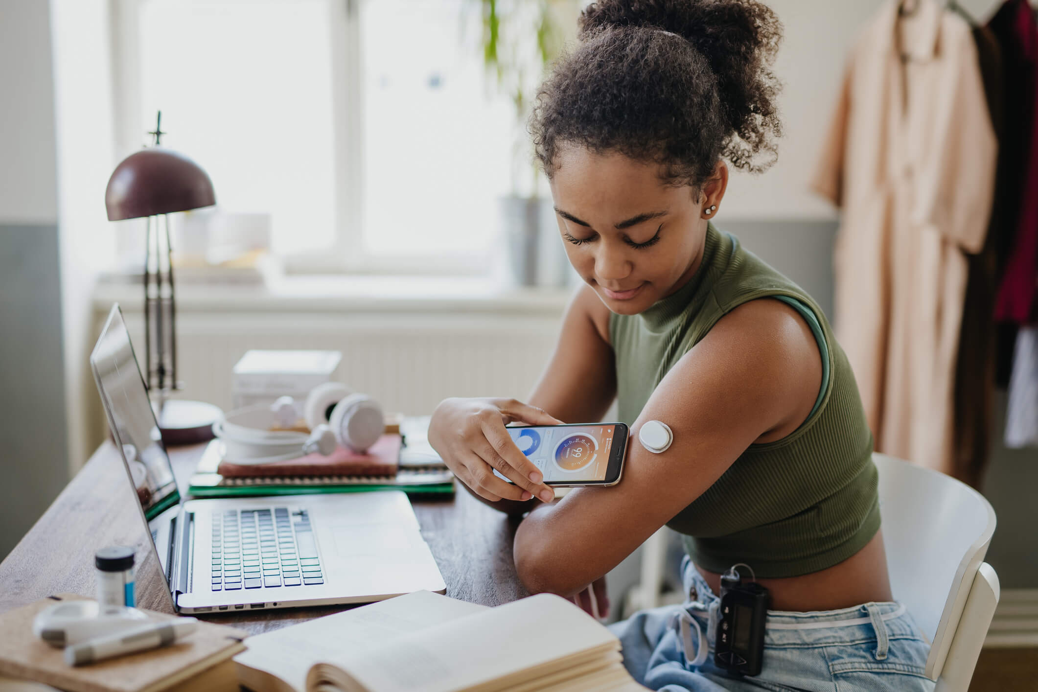 Young woman using an app to measure her glucose monitor