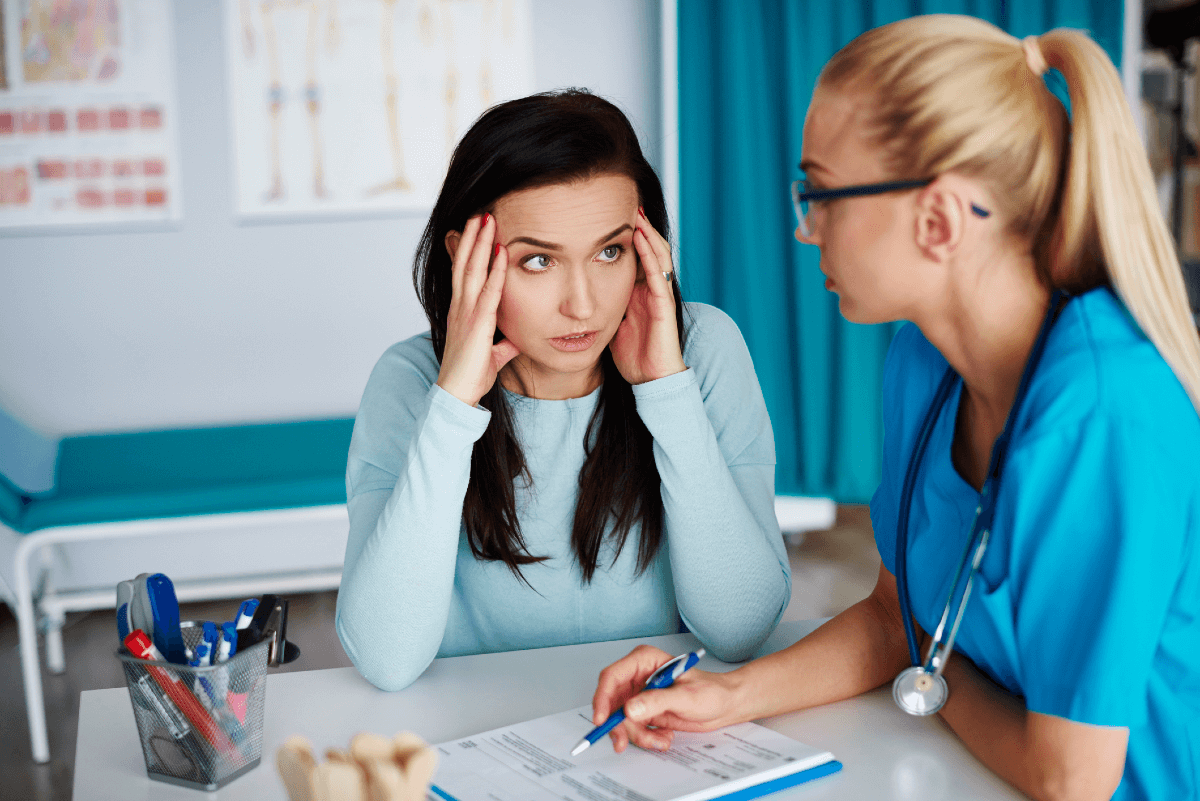 Frustrated patient talking to a medical professional about a medical form in doctor's office