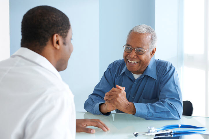 Older man speaking to a medical professional