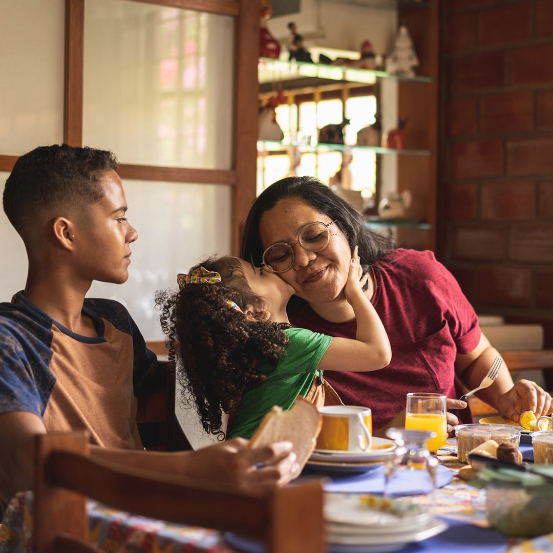 Family of three sitting at the breakfast table