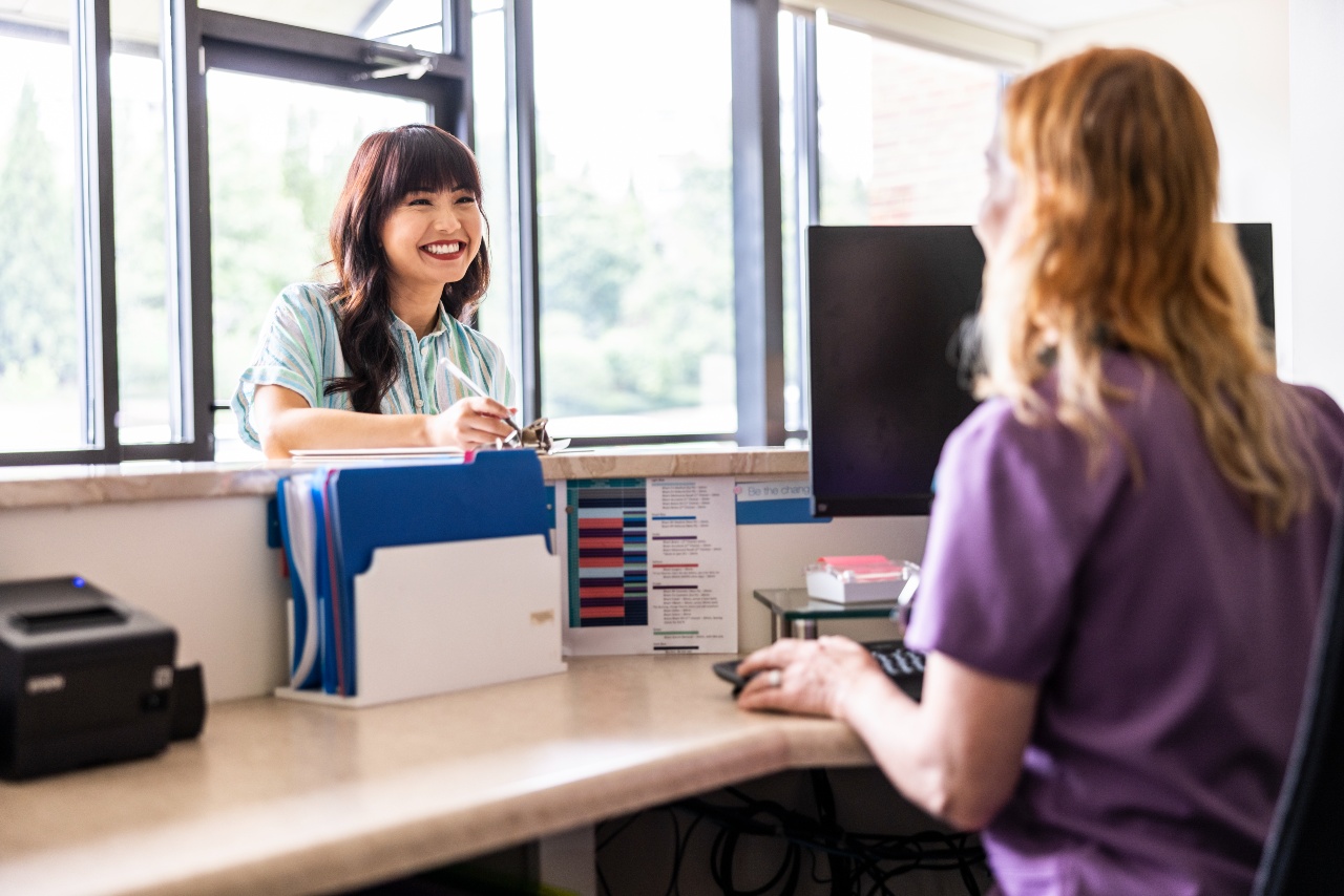 Patient checking in at an admin desk