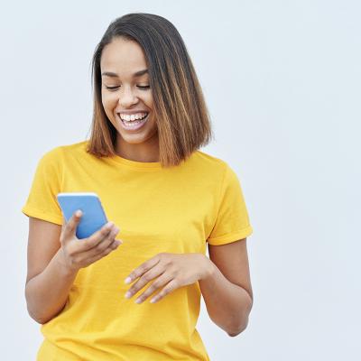 Woman laughing at her phone screen