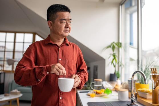 Man looking out the window in the kitchen
