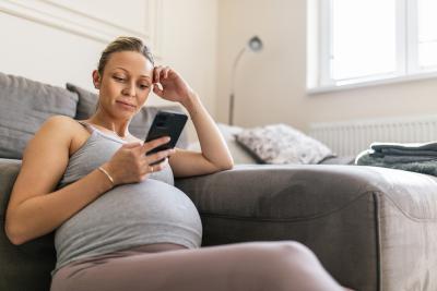 Pregnant woman looking at her phone